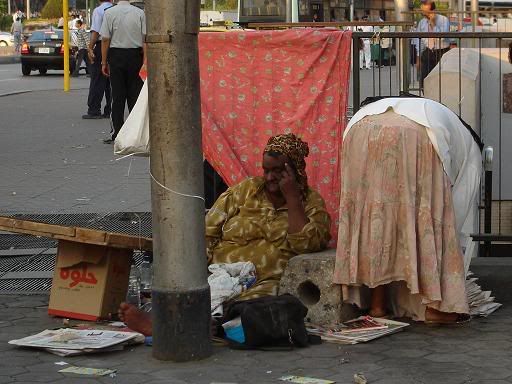 Some people sell newspapers on the streets to make a bit of money.
